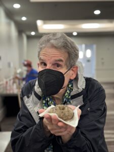 Scott Edelman tempts with a donut at our 60th Anniversary Nebula Awards Conference. (Photo Credit: Kaitrin Acuna, 2025.)