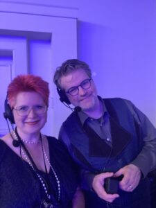 Your team behind the scenes! (And in them!) Rebekah Postupak and Josh Storey bringing the Nebula Awards Ceremony to life (with a little help from all the guests who make the event so special in the first place!). (Photo Credit: Kate Ristau, 2025.)