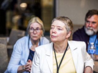 SFWA Grand Master Nicola Griffith and Kelley Eskridge (wife and fellow writer), watching events beyond the frame at the 60th Anniversary Nebula Awards Conference. (Photo Credit: Kaitrin Acuna, 2025.)
