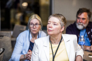 SFWA Grand Master Nicola Griffith and Kelley Eskridge (wife and fellow writer), watching events beyond the frame at the 60th Anniversary Nebula Awards Conference. (Photo Credit: Kaitrin Acuna, 2025.)