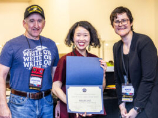 SFWA CFO Jonathan P. Brazee (left) and SFWA President (Kate Ristau) celebrate Nebula Finalist Pinki Li. (Photo Credit: Kaitrin Acuna, 2025.)