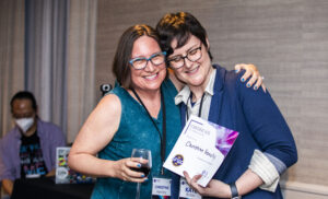 Christine Hanolsy receives a certificate of appreciation from SFWA President Kate Ristau. (Photo Credit: Kaitrin Acuna, 2025.)