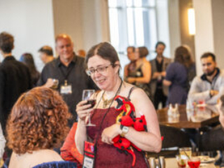 Jennifer Povey and a glorious red dragon mingle at our 60th Anniversary Nebula Awards Conference. (Photo Credit: Kaitrin Acuna, 2025.)