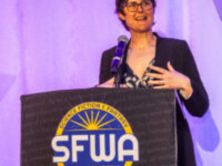 SFWA President Kate Ristau warmly welcomes the audience to another year at SFWA. (Photo Credit: Kaitrin Acuna, 2025.)