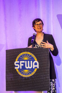 SFWA President Kate Ristau warmly welcomes the audience to another year at SFWA. (Photo Credit: Kaitrin Acuna, 2025.)