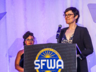 Toastmaster Erin Roberts and SFWA President Kate Ristau, co-presenting at the Nebula Awards Ceremony. (Photo Credit: Kaitrin Acuna, 2025.)