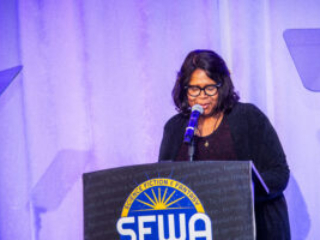 SFWA Board Member Christine Taylor-Butler (Director-at-Large) introduces an award at the 60th Anniversary Nebula Awards Ceremony. (Photo Credit: Kaitrin Acuna, 2025.)