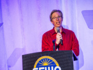 SFWA Vice President Anthony Eichenlaub introduces an award at our 60th Anniversary Nebula Awards Ceremony, held on Saturday, June 7. (Photo Credit: Kaitrin Acuna, 2025.)