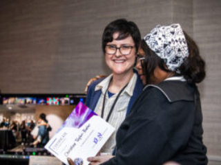 Christine Taylor-Butler receives a certificate of appreciation from SFWA President Kate Ristau. (Photo Credit: Kaitrin Acuna, 2025.)