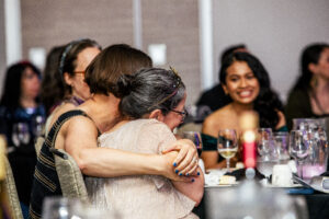 Joyous attendees embracing at our Nebula Awards Banquet Dinner and Ceremony on June 7, 2025. (Photo Credit: Kaitrin Acuna, 2025.)