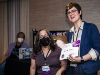 Jennifer Hudak receives a certificate of appreciation from SFWA President Kate Ristau. (Photo Credit: Kaitrin Acuna, 2025.)