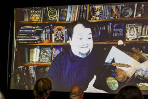 Nebula Award Winner John Wiswell introduces his new award to its &quot;siblings&quot;, joining us online at the 60th Anniversary Nebula Awards Conference. (Photo Credit: Kaitrin Acuna, 2025.)