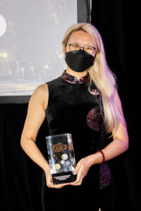 Nebula Award Winner Jingjing Xiao accepts the Nebula Award for Best Game Writing for the whole team responsible for A Death in Hyperspace. (Photo Credit: Kaitrin Acuna, 2025.)