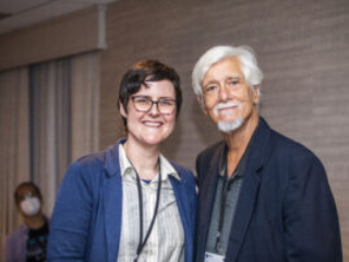 SFWA President Kate Ristau and Past SFWA President Michael Capobianco share a moment in time and space at the 60th Anniversary Nebula Awards Conference. (Photo Credit: Kaitrin Acuna, 2025.)