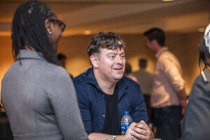 SFWA Executive Director Isis Asare and SFWA Volunteer Nathan Lucas enjoy conversation at our 60th Anniversary Nebula Awards Conference. (Photo Credit: Kaitrin Acuna, 2025.)