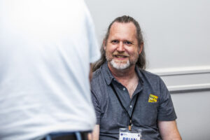 Brian C. E. Buhl gives us a grin at our Nebula Awards Conference. (Photo Credit: Kaitrin Acuna, 2025.)