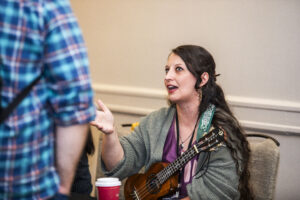 J.H. Fleming carries music into conversation with attendees at our Nebula Awards Conference. (Photo Credit: Kaitrin Acuna, 2025.)