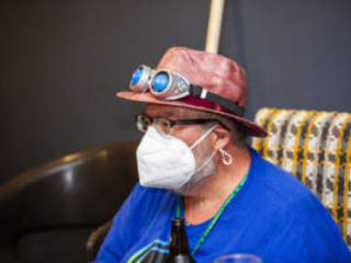 A Nebula attendee comes prepared! SFWA Board Member Steven D. Brewer with goggles and mask at the ready. (Photo Credit: Kaitrin Acuna, 2025.)