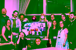 In-person, from left to right: Ray Nayler, Christine Hanolsy, Paul Dean, Benjamin Rosenbaum, Pinki Li, Remy Siu, Jingjing Xiao, Aimee Ogden, A.W. Prihandita, Jennifer Hudak, Abby Howard, Tony Howard-Arias  On-screen, left to right: Row 1 - Angela Liu, Darusha Wehm, Isabel J. Kim; Row 2 - Jordan Kurella, José Pablo Iriarte, Kate Heartfield; Row 3 - Sofia Samatar, Vanessa Ricci-Thode. (Photo Credit: Kaitrin Acuna, 2025.)